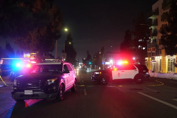 Police patrol vehicles close Vermiont Ave. after a vehicle rammed into a crowd gathered outside "The Vermont" nightclub in Los Angeles, early morning Saturday, July 19, 2025. (AP Photo/Damian Dovarganes)