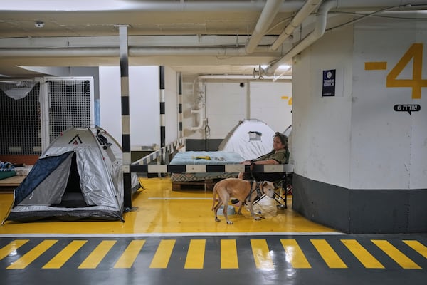 People take shelter in a parking garage as a precaution against possible Iran missile attacks, in Tel Aviv, Israel, Wednesday, June 18, 2025. (AP Photo/Ohad Zwigenberg)