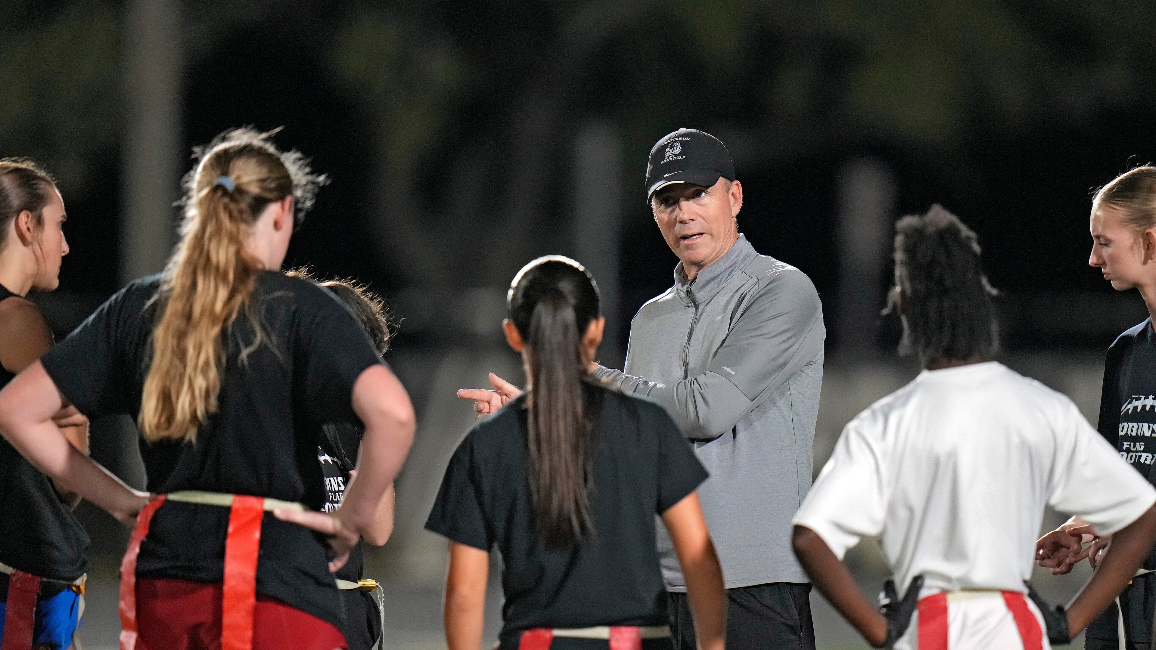 Robinson High School girls flag football coach Joshua Saunders talks to some of his players during a practice, Wednesday, Nov. 5, 2025, in Tampa, Fla. (AP Photo/Chris O'Meara)