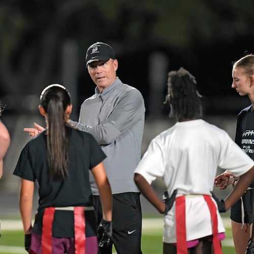 Robinson High School girls flag football coach Joshua Saunders talks to some of his players during a practice, Wednesday, Nov. 5, 2025, in Tampa, Fla. (AP Photo/Chris O'Meara)