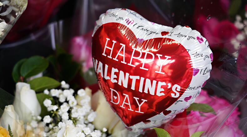 Valentine's Day balloons and flowers are sold outside a convenience store on Feb. 14, 2021, in New York City. (Cindy Ord/Getty Images/TNS)