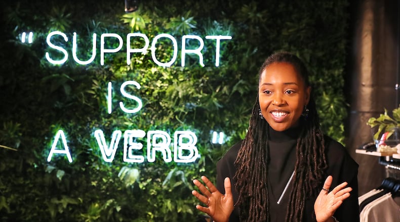 112320 Atlanta: Owner Lakeysha Hallmon discusses the concept of her store The Village at Ponce City Market with a large tag line to the community prominently displayed on one of the main walls on Monday, Nov 23, 2020, in Atlanta. “Curtis Compton / Curtis.Compton@ajc.com”