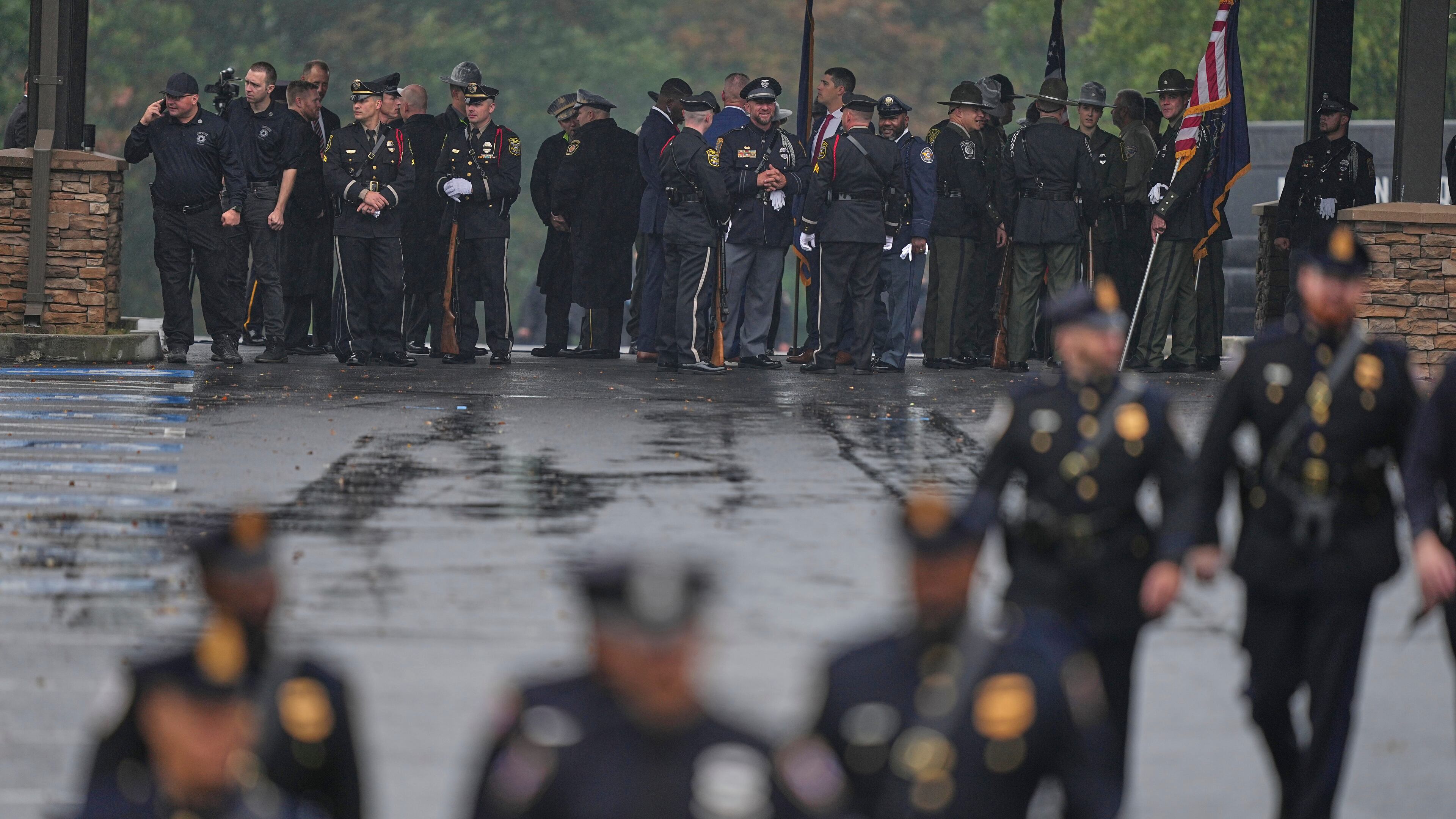 Officers gather ahead of funeral services for slain Northern York County Regional Police detectives Cody Michael Becker, Mark Edward Baker and Isaiah Emenheiser, Thursday, Sept. 25, 2025, in Red Lion, Pa. (AP Photo/Matt Rourke)