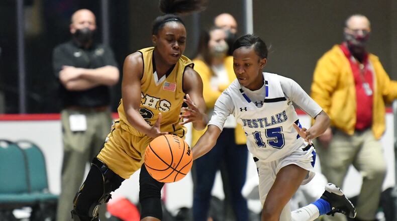 Westlake's Cynthia Walton (15) steals a ball from Carrollton's Kehinde Obasuyi (2) during Friday's 6A girls state title game in Macon.