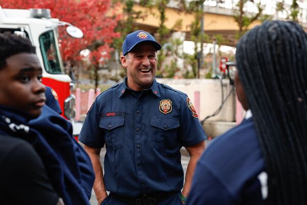 Sgt. Chris Moss of Atlanta Fire Rescue speaks to Johnny Jones, 13 and his cousin Malai Moore, 11 at Fire Station 11 on Thursday, Nov. 21, 2025. Firefighters rescued Jones and Moore from an elevator that became stuck in a blind shaft. The teens were trapped for several hours before crews reached them. (Natrice Miller/ AJC) 
