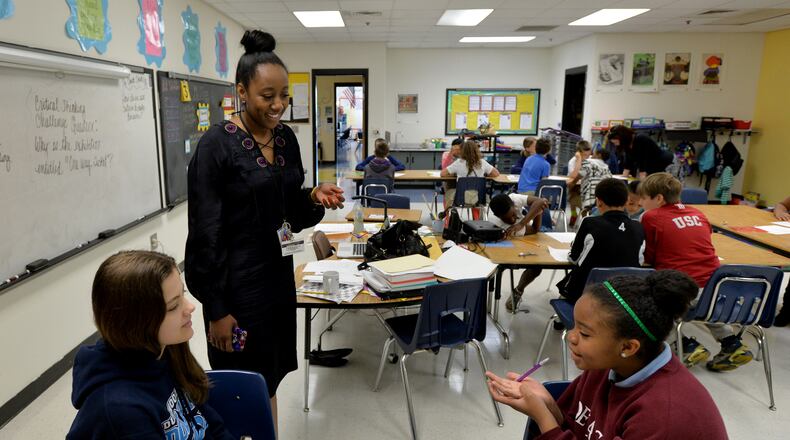 April 21, 2015 Sandy Springs, GA: Patrice Dawkins-Jackson helps gifted 5th grade students Jordana Andrade and Meah Poret at Dunwoody Springs Elementary. After years of budget cuts, teachers in Georgia are expected to receive significant raises next school year. BRANT SANDERLIN/BSANDERLIN@AJC.COM