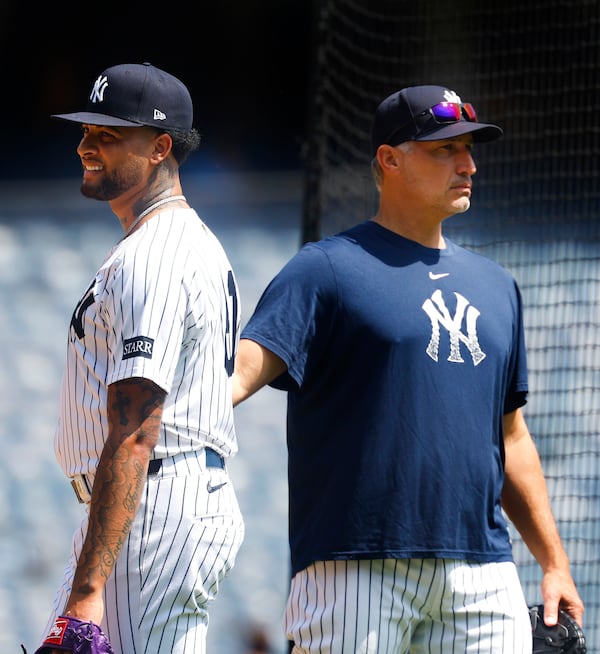 New York Yankees' Luis Gil, left, and Andy Pettitte, right, look on during live batting practice before a baseball game between the New York Yankees and the Baltimore Orioles, Saturday, June 21, 2025, in New York. (AP Photo/Noah K. Murray)