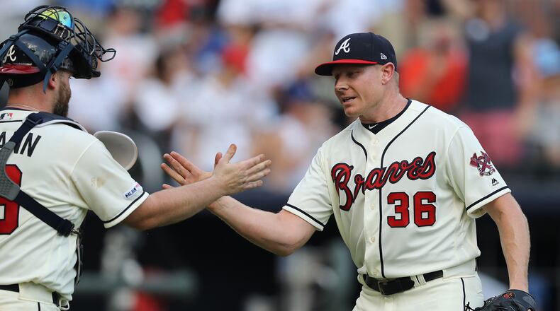 Braves reliever Mark Melancon is congratulated by catcher Brian McCann after closing out the 5-3 victory over the Los Angeles Dodgers Sunday, Aug. 18, 2019, at SunTrust Park in Atlanta.
