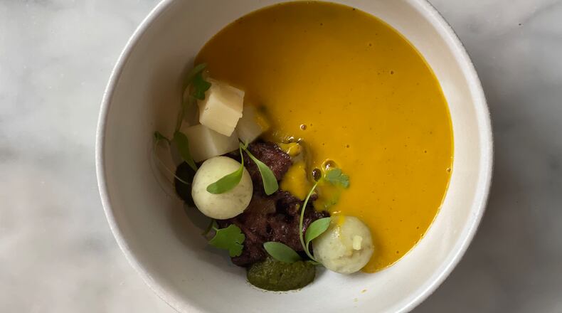 At Bread & Butterfly, soup joumou, one of Haiti’s national dishes, comes with a tableside pour of silky pureed squash. Courtesy of Bread & Butterfly