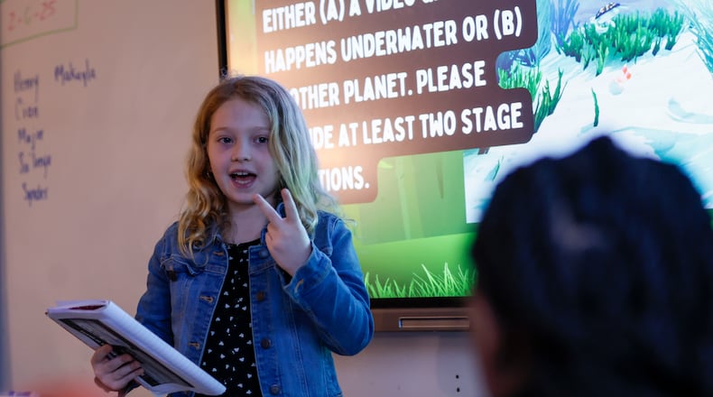A fourth grade student interacts with classmates during a reading class at Parkside Elementary. Recently released national test scores indicated a significant increase in fourth grade reading scores in the APS district.