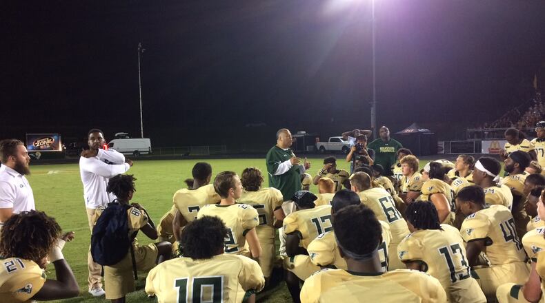 Grayson surrounds ooach Christian Hunnicutt after the game.