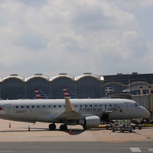 FILE - An American Eagle plane is parked at a gate at the Ronald Reagan Washington National Airport in Arlington, Va., June 29, 2026. (AP Photo/Carolyn Kaster, File)