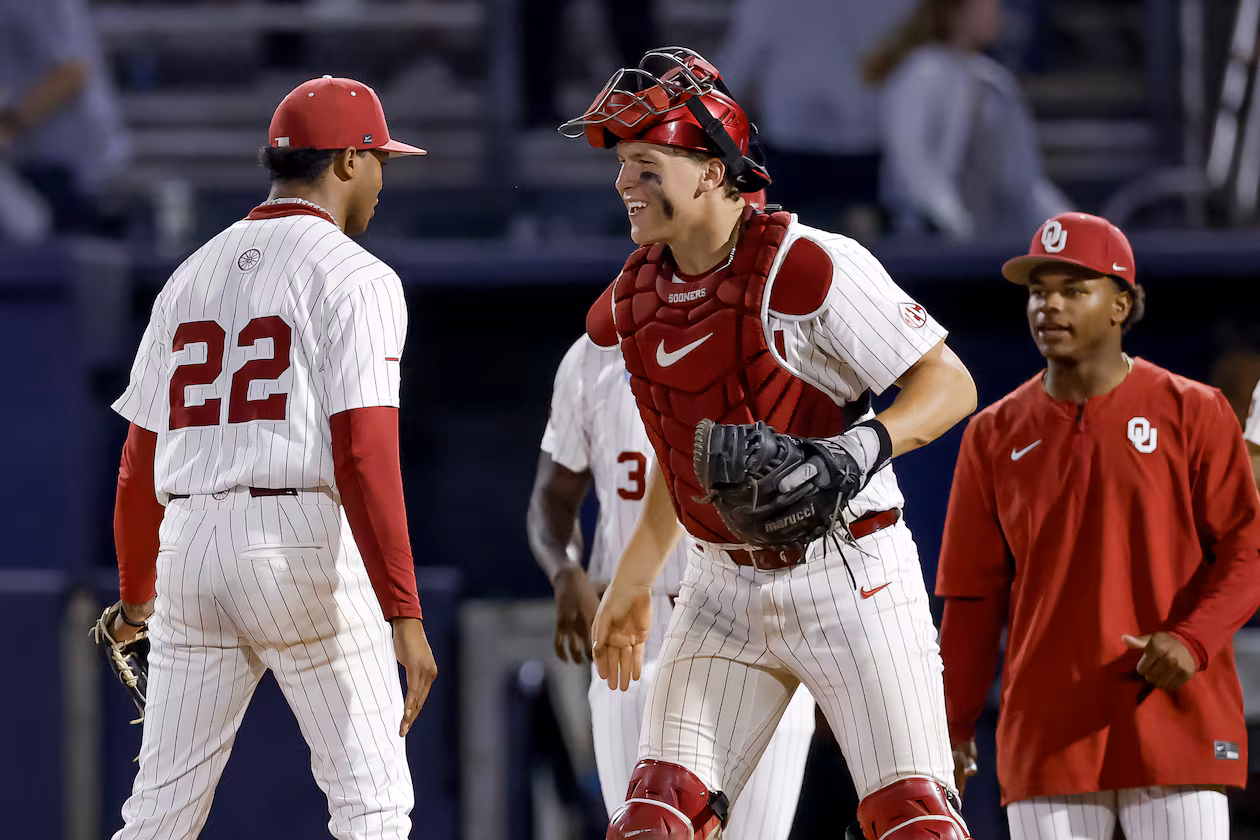 Oklahoma pitcher Lj Mercurius, left, celebrates with catcher Deiten Lachance, center, after defeating Georgia Tech in the ninth inning of the NCAA D1 Atlanta Regional elimination baseball game at Russ Chandler Stadium, Sunday, May 31, 2026, in Atlanta. The Yellow Jackets lost to the Sooners and will have to play on Monday, June 1. (Erik S. Lesser for the AJC)