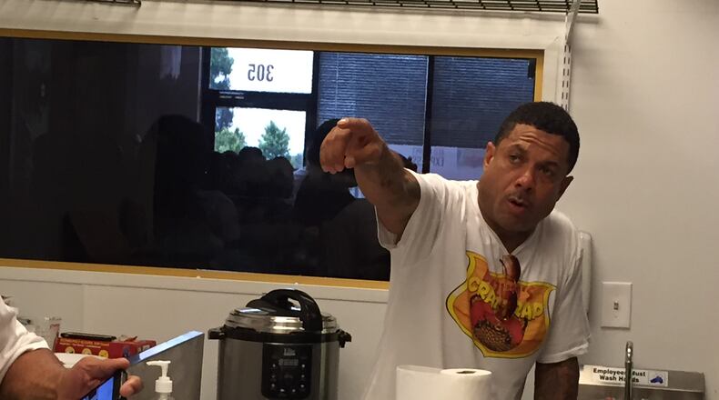 Benzino running the kitchen on opening day Sunday, July 19, 2015 of his new Marietta eatery Benzino's Crab Trap. CREDIT: Rodney Ho/rho@ajc.com