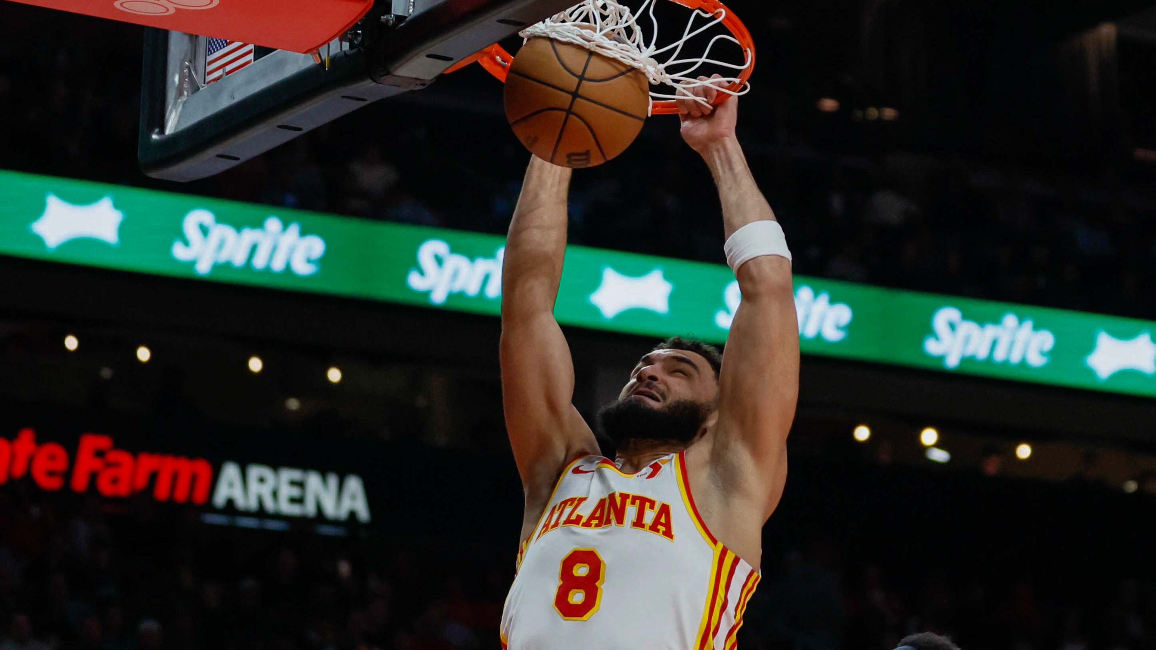 David Roddy, here dunking against the Celtics in November, played 27 games for the Hawks last season before being waived to make roster room following a slew of deals just before the trade deadline. (Miguel Martinez/AJC)