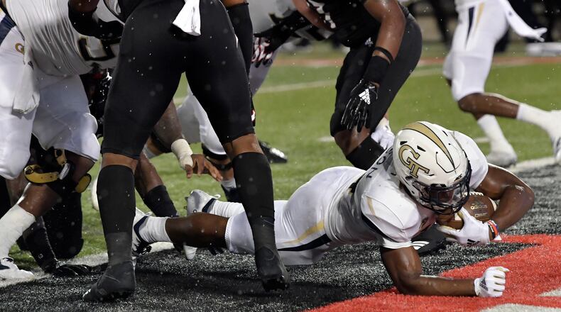 Georgia Tech running back Jordan Mason (24) busts through the Louisville line to score a touchdown during the first half of an NCAA college football game, Friday, Oct. 5, 2018, in Louisville, Ky. (AP Photo/Timothy D. Easley)