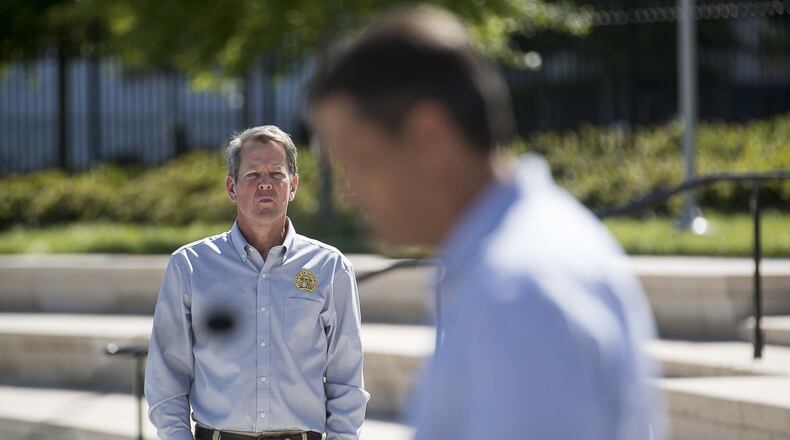 Georgia Gov. Brian Kemp listens as Lt. Gov. Geoff Duncan makes remarks during a press conference across from the State Capitol building in Atlanta on April 20, 2020. (ALYSSA POINTER / ALYSSA.POINTER@AJC.COM)