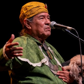 Muscogee (Creek) elder, William Harjo, plays a flute he made by hand and tells stories at the Art of Activism at 7 Stages Theatre in Atlanta on Friday, Nov. 14, 2025. (Olivia Bowdoin for the AJC)