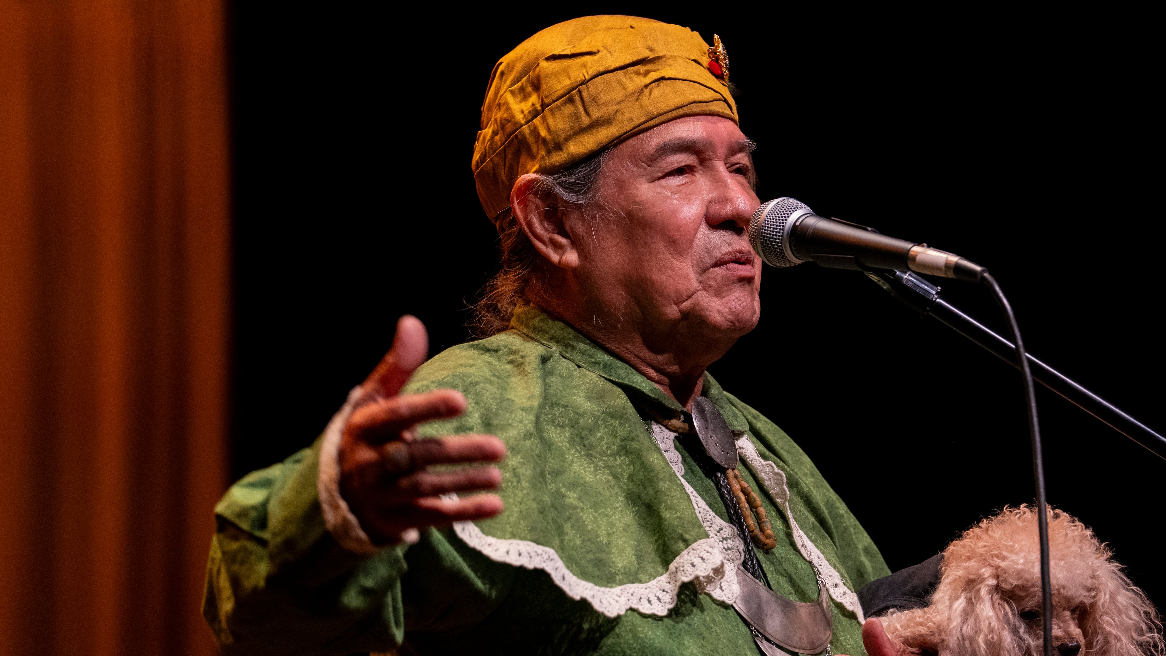 Muscogee (Creek) elder, William Harjo, plays a flute he made by hand and tells stories at the Art of Activism at 7 Stages Theatre in Atlanta on Friday, Nov. 14, 2025. (Olivia Bowdoin for the AJC)