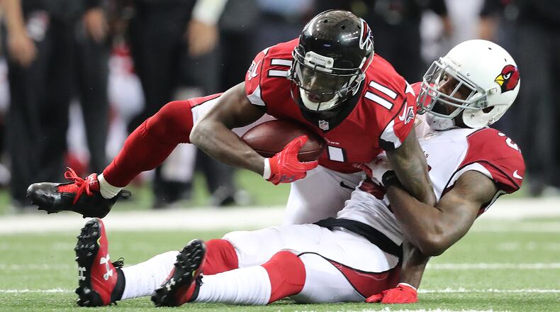 Falcons wide receiver Julio Jones makes a first down catch against Cardinals cornerback Patrick Peterson during the second quarter in an NFL football game on Sunday, Nov. 27, 2016, in Atlanta. Curtis Compton/ccompton@ajc.com