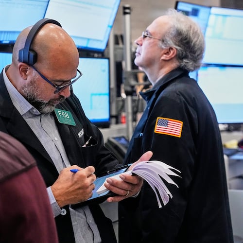 Options trader Steven Rodriguez, center, works on the floor of the New York Stock Exchange, Monday, Oct. 20, 2025. (AP Photo/Richard Drew)