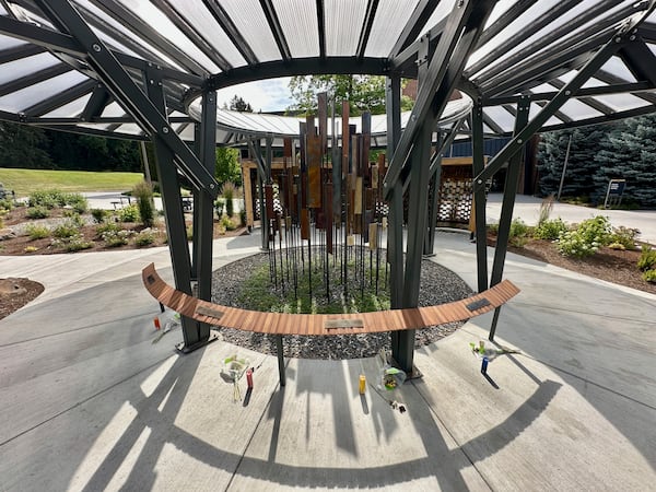 During their memorial, flowers and candles are seen below the names of the University of Idaho students who were killed in November 2022 at their off campus house in Moscow, Idaho, Tuesday, July 1, 2025. (AP Photo/Manuel Valdes)