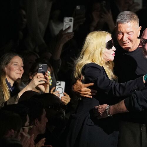 FILE -Madonna congratulates Domenico Dolce, right, and Stefano Gabbana at the end of the Dolce & Gabbana Fall/Winter 2026-2027 Women's collection, presented in Milan, Italy, Feb. 28, 2026. (AP Photo/Antonio Calanni), File)