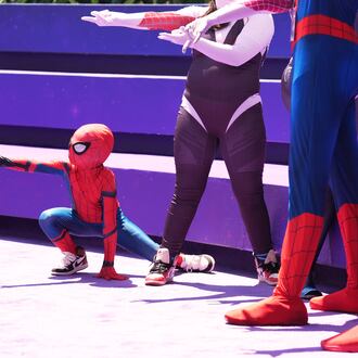 Daniel Delgado, 6, of Victorville, Calif., joins a photo op for cosplayers dressed as "Spider-Man" during D23: The Ultimate Disney Fan Event on Friday, Aug. 14, 2026, at the Anaheim Convention Center in Anaheim, Calif. (Chris Pizzello/AP)