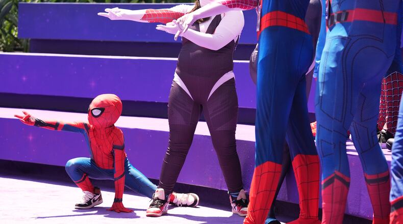 Daniel Delgado, 6, of Victorville, Calif., joins a photo op for cosplayers dressed as "Spider-Man" during D23: The Ultimate Disney Fan Event on Friday, Aug. 14, 2026, at the Anaheim Convention Center in Anaheim, Calif. (Chris Pizzello/AP)