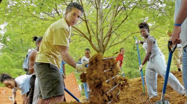Larry Schall (in yellow) has taken hands-on approach as president of Oglethorpe University. Applications to the small liberal arts college in Brookhaven have quadrupled since he's taken over in 2005.