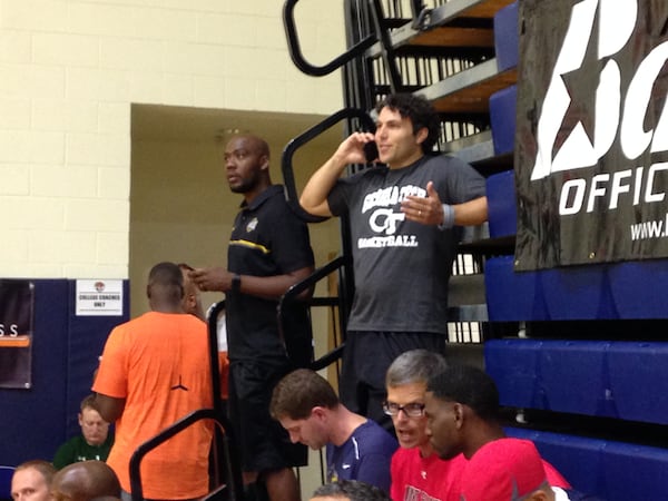 Georgia Tech coach Josh Pastner on a phone call while watching an AAU game at Bishop Gorman High School in Las Vegas July 27, 2017. Pastner stands up in the bleachers at the end of the court to ensure visibility.