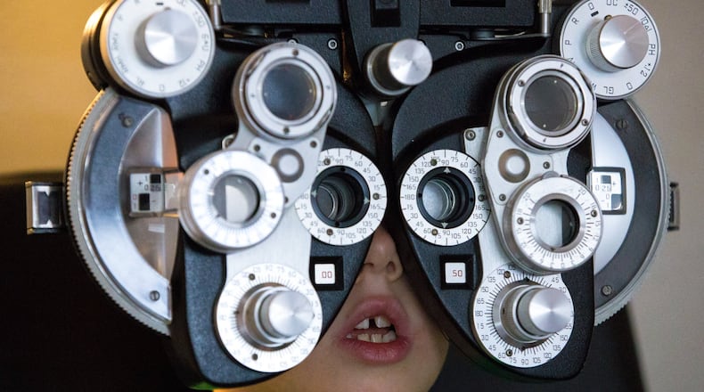 Aiden Crow, 7, is shown during a free eye exam in a mobile clinic at the Gwinnett County library in Snellville on Friday, Aug. 2, 2019. The free exams have no income requirement and provide glasses to children who need them. CASEY SYKES FOR THE ATLANTA JOURNAL-CONSTITUTION