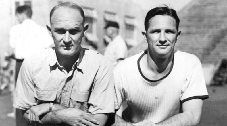 Mack Tharpe, left, poses with Bobby Dodd, right, during their tenure as assistant coaches to William Alexander at Georgia Tech. Alexander, in fact, is visible in the background of the photo between Tharpe and Alexander. (Georgia Tech archives)