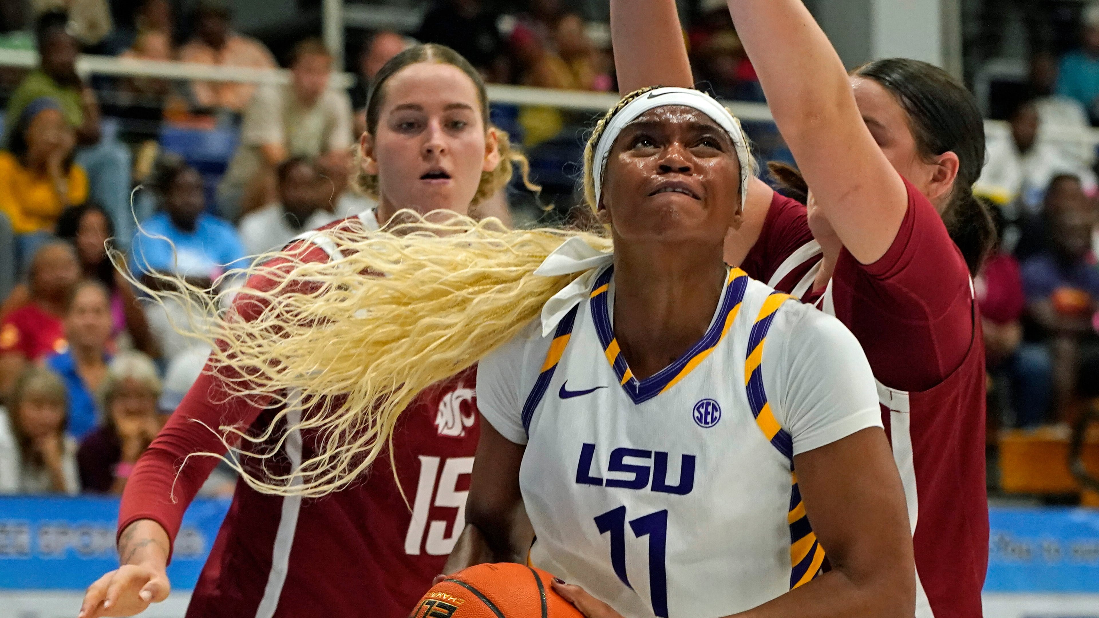LSU guard ZaKiyah Johnson, center, drives for a shot between Washington State defenders Keandra Koorits, left, and Malia Ruud during the first quarter of their Reef Division championship game at the Paradise Jam NCAA college basketball tournament in St. Thomas, U.S. Virgin Islands, Saturday, Nov. 29, 2025. (Bill Kiser/Virgin Islands Daily News via AP)