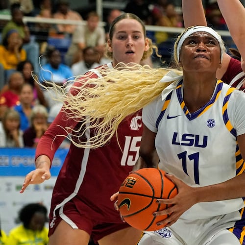 LSU guard ZaKiyah Johnson, center, drives for a shot between Washington State defenders Keandra Koorits, left, and Malia Ruud during the first quarter of their Reef Division championship game at the Paradise Jam NCAA college basketball tournament in St. Thomas, U.S. Virgin Islands, Saturday, Nov. 29, 2025. (Bill Kiser/Virgin Islands Daily News via AP)