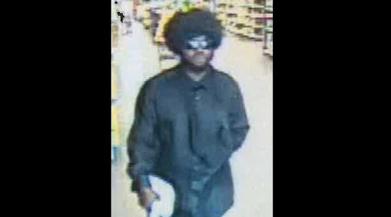 Cobb County police say this man with a wig and sunglasses robbed two Walmart stores within 15 minutes on Aug. 14, 2018.
