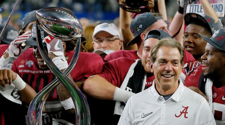Alabama coach Nick Saban pauses next to the Field Scovell Trophy after his team's Cotton Bowl semifinal playoff game against Michigan State, Thursday night in Arlington, Texas. Alabama won 38-0 to advance to the national championship game. (AP photo)