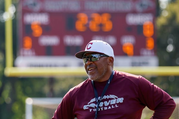Carver High football coach Darren Myles has standards on and off the field. His players are required to wear dress shirts and ties on Wednesdays, for example. (Miguel Martinez/AJC)