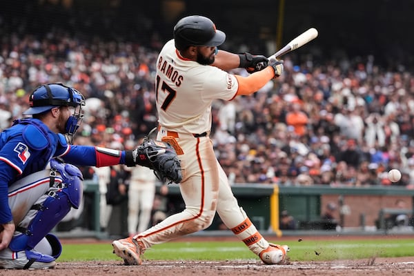 San Francisco Giants' Heliot Ramos (17) hits a single during the ninth inning of a baseball game against the Texas Rangers, Sunday, April 27, 2025, in San Francisco. (AP Photo/Godofredo A. Vásquez)