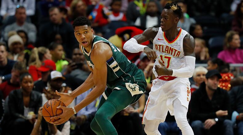 Dennis Schroder  of the Atlanta Hawks defends against the Giannis Antetokounmpo of the Milwaukee Bucks at Philips Arena on October 29, 2017 in Atlanta, Georgia.