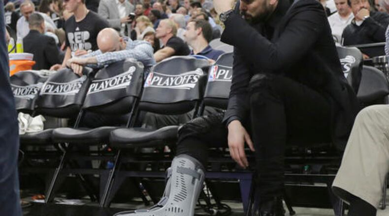 Memphis Grizzlies center Marc Gasol, who is out with a foot injury, sits on the bench during the second half in Game 2 of a first-round NBA basketball playoff series against the San Antonio Spurs, Tuesday, April 19, 2016, in San Antonio. San Antonio won 94-68. (AP Photo/Eric Gay)