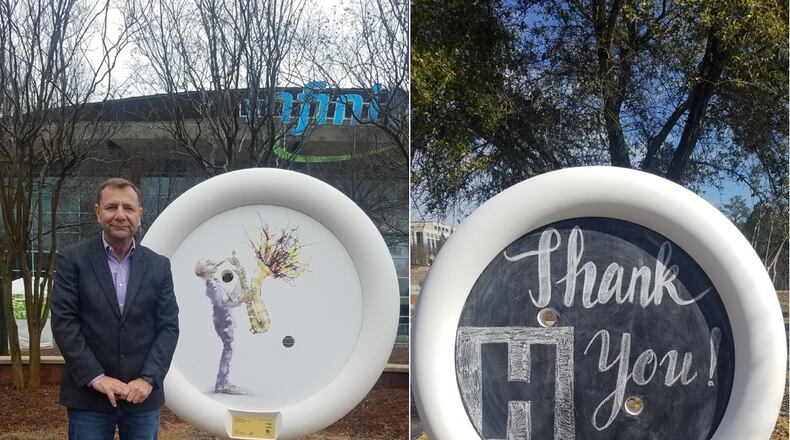 Stan Hall (left), Infinite Energy Center Chief Operating Officer, unveils Button Sculpture #16, “JAZZ” by artist Bill Stevens. On the right is an interactive chalkboard Button Sculpture installed outside the Hudgens Center for the Arts. (Courtesy Button Art, Inc.)