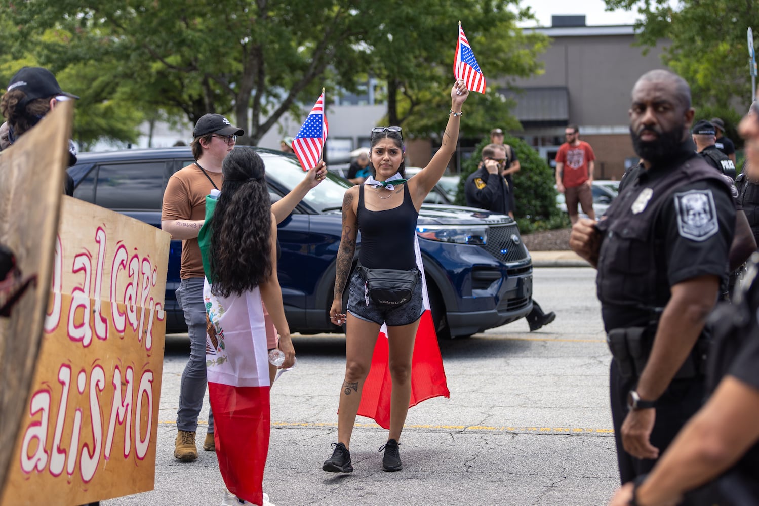 Demonstrators chant as police block their marching route during a protest on ICE raids and deportation arrests on Chamblee Tucker Road in Atlanta on Saturday, June 14, 2025. (Arvin Temkar / AJC)