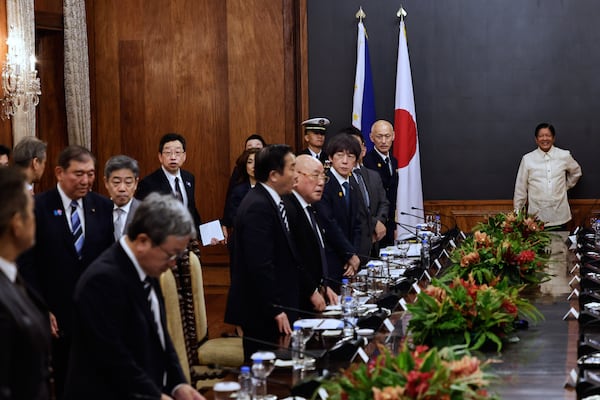 Philippines President Ferdinand Marcos Jr., right, waits for Japan's Prime Minister Shigeru Ishiba, second left, to join him for a photo opportunity before the start of a bilateral meeting at Malacanang Palace in Manila, Philippines Tuesday, April 29, 2025. (Rolex Dela Pena/Pool Photo via AP)