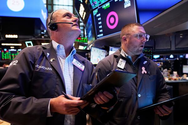 Traders Jonathan Corpina, left, and Ryan Falvey work on the floor of the New York Stock Exchange, Thursday, April 17, 2025. (AP Photo/Richard Drew)