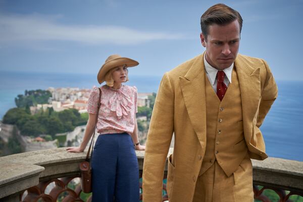 Lily James, left, as Mrs. de Winter, Armie Hammer as Maxim de Winter in"Rebecca". (Kerry Brown/Netflix/TNS)