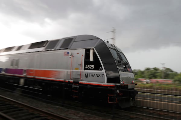 FILE - A New Jersey Transit train leaves the Bound Brook Station, Friday, Aug. 3, 2018, in Bound Brook, N.J. Commuters were faced with many train cancellations during the morning rush hour. (AP Photo/Julio Cortez, File)