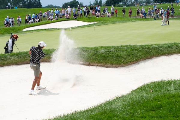 FILE - Charlie Woods hits onto the 17th green during the first round of stroke play of the U.S. Junior Amateur Golf Championship, in Bloomfield Township, Mich., July 22, 2024. (AP Photo/Carlos Osorio, File)