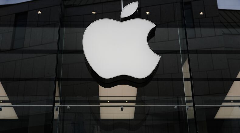 FILE - The Apple logo is illuminated at a store in Munich, April 2, 2026. (AP Photo/Matthias Schrader, File)