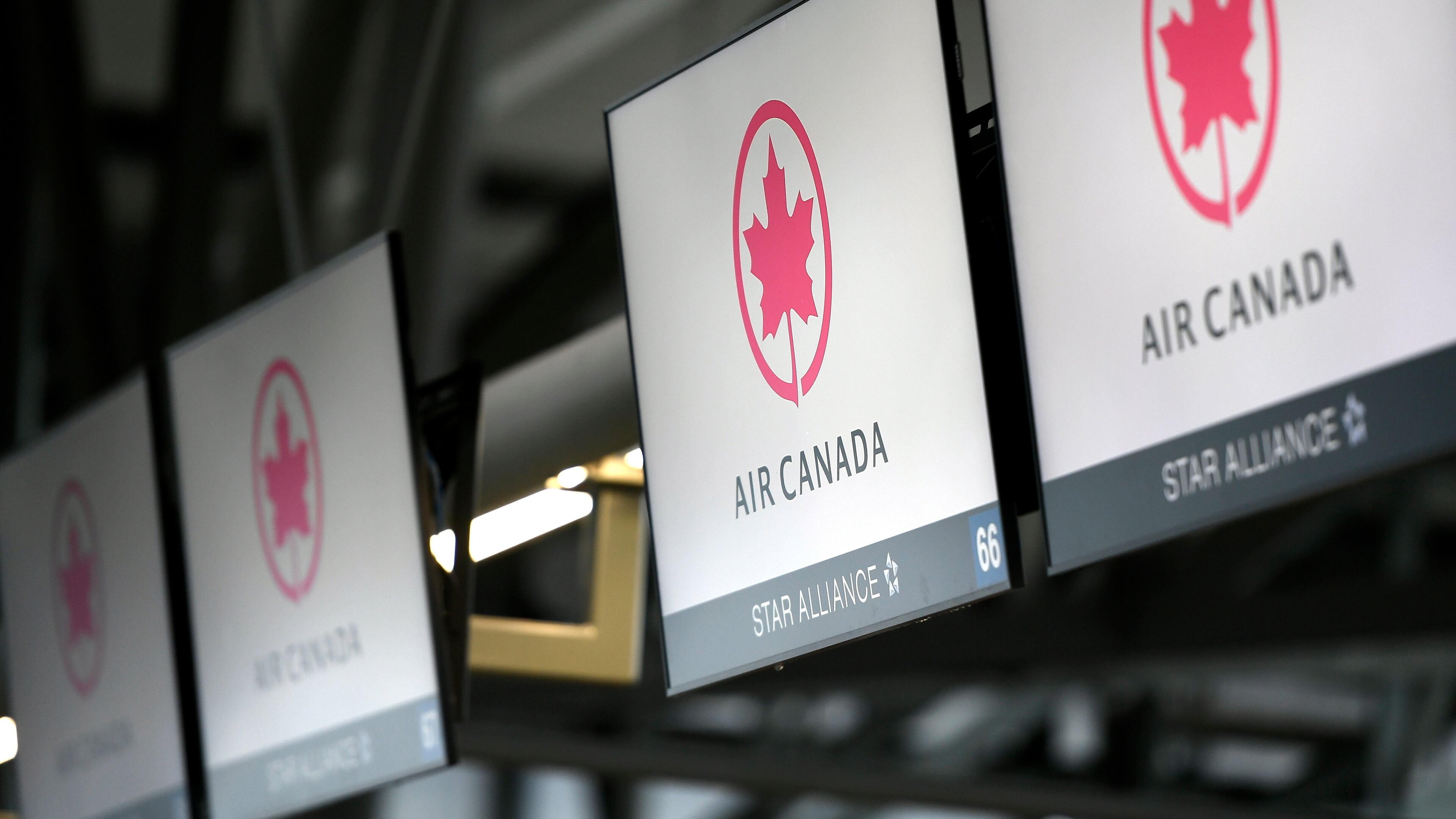 FILE - This May 16, 2020 file photo shows Air Canada check screens at Ottawa International Airport in Ottawa, Ontario, Canada. (Justin Tang/The Canadian Press via AP, File)
